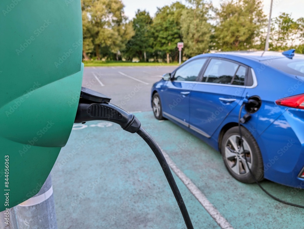 Blue Electric car charging at station point, eco auto, green vehicle, automotive background