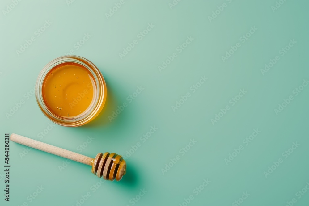 Honey and Dipping Stick on Green Background Honey and Dipping Stick on Green Background