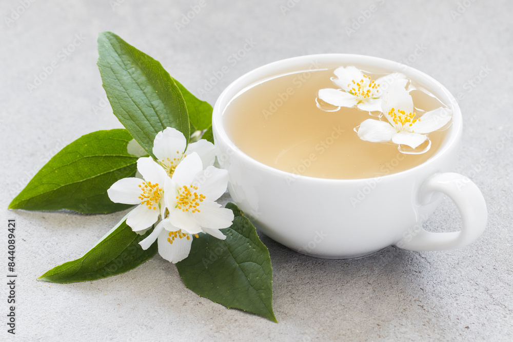 Tea with jasmine in a white cup. Close-up Tea with jasmine in a white cup. Close-up
