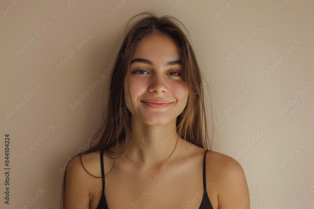 A close up portrait of a young woman with a subtle smile A close up portrait of a young woman with a subtle smile