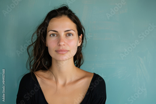 A close up portrait of a young woman with a subtle smile