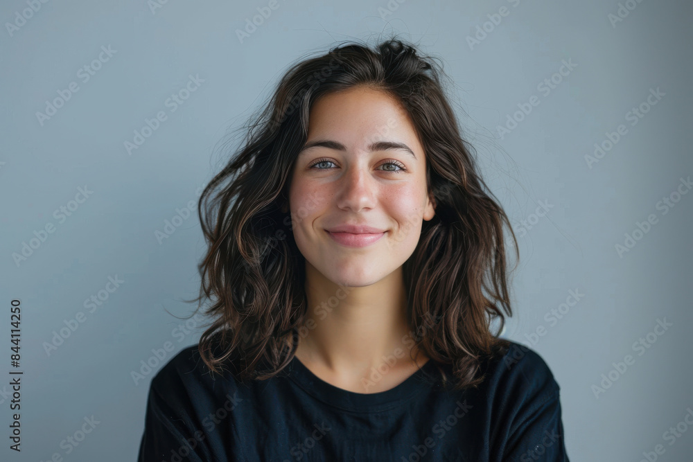 Fototapeta premium A close up portrait of a young woman with a subtle smile