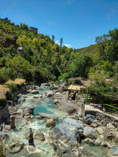 Oued El Bared River and Waterfall, Setif, Algeria. wooden cabins and terraces by the river in Algeria's Sétif province, which is one of its biggest tourist attractions photo