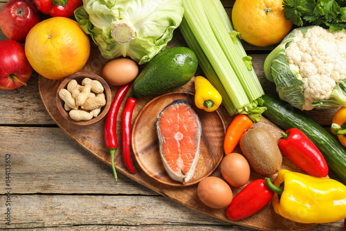 Healthy meal. Different vegetables and raw salmon on wooden table  flat lay