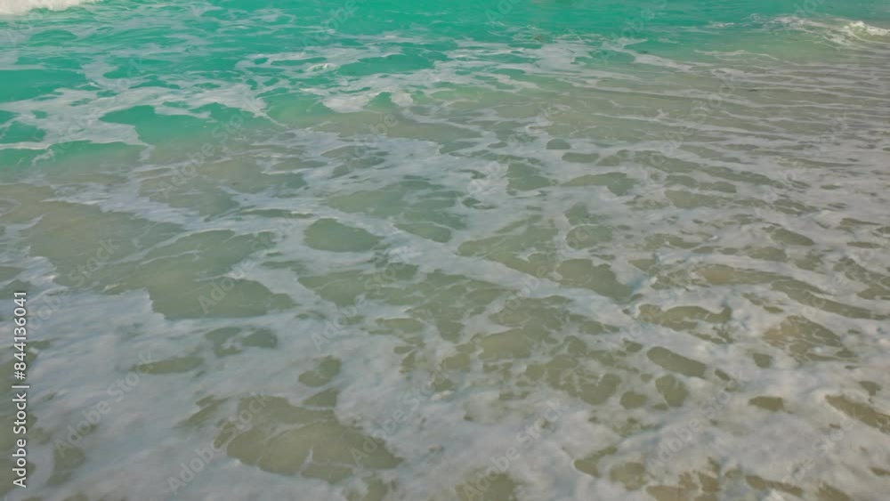 Beautiful view of large turquoise waves of the Caribbean Sea rolling onto the sandy beach of Mexico. Beautiful view of large turquoise waves of the Caribbean Sea rolling onto the sandy beach of Mexico.