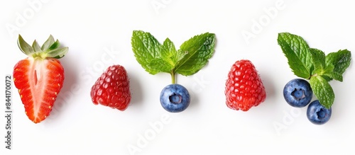 Fresh berries isolated on white background from a top view  strawberry  raspberry  blueberry  and mint leaf arranged stylishly.