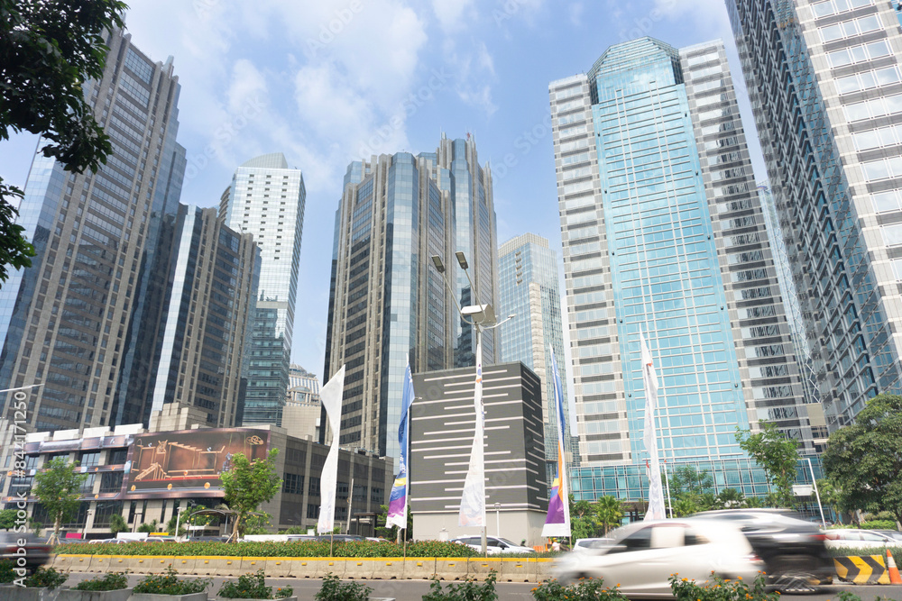 Modern office buildings complex against blue sky. Jakarta Indonesia skyline viewed from the street with facade of apartments, condominiums and offices. Modern office buildings complex against blue sky. Jakarta Indonesia skyline viewed from the street with facade of apartments, condominiums and offices.