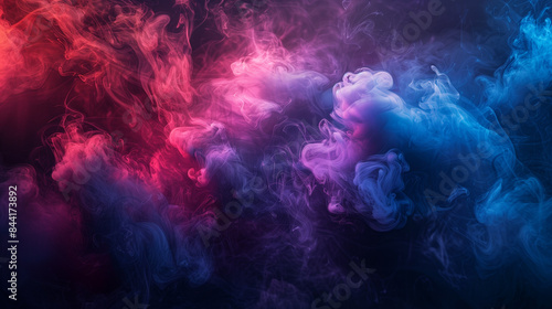 Colorful smoke curls on dark background