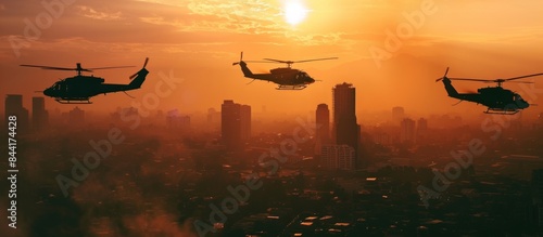 Silhouette of three army helicopters doing patrols while flying over downtown, shot at sunset time photo