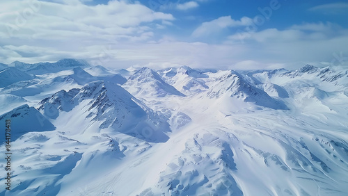 Breathtaking Aerial View of Snow-Covered Mountain Range Under Clear Blue Sky