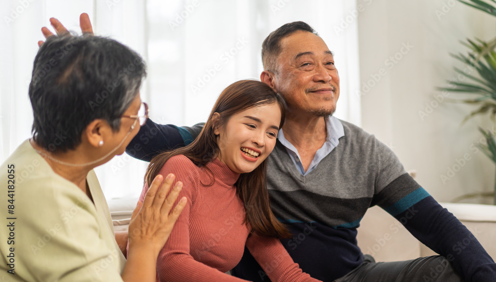 Portrait enjoy happy smiling love asian family.Senior mature father hug with elderly mother and young adult woman play laughing and having fun together at home.insurance concept Portrait enjoy happy smiling love asian family.Senior mature father hug with elderly mother and young adult woman play laughing and having fun together at home.insurance concept