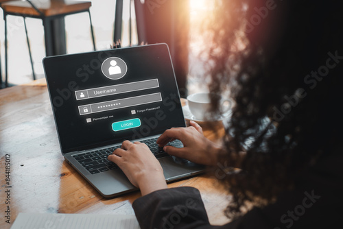 Login and password concept, Businesswoman using laptop computer on desk with login and password icon on virtual screen, cyber security, data protection and secured internet access, cybersecurity