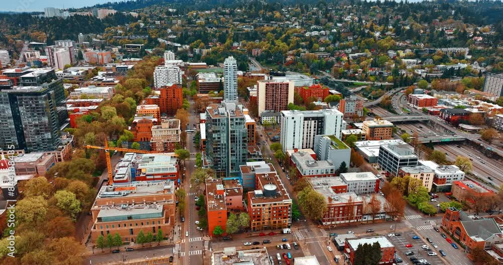 Lots of greenery in the residential area with multi-storied buildings and low cottages. Scenic view of Portland, Oregon, United States from top. Lots of greenery in the residential area with multi-storied buildings and low cottages. Scenic view of Portland, Oregon, United States from top.