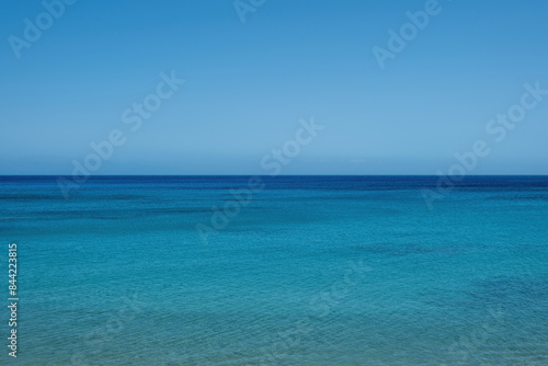 Fototapeta Naklejka Na Ścianę i Meble -  Ripple sea joins with blue sky background texture. Empty clear sea water surface. Copy space