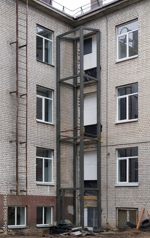 Construction of an external elevator for the disabled in an old brick building Construction of an external elevator for the disabled in an old brick building