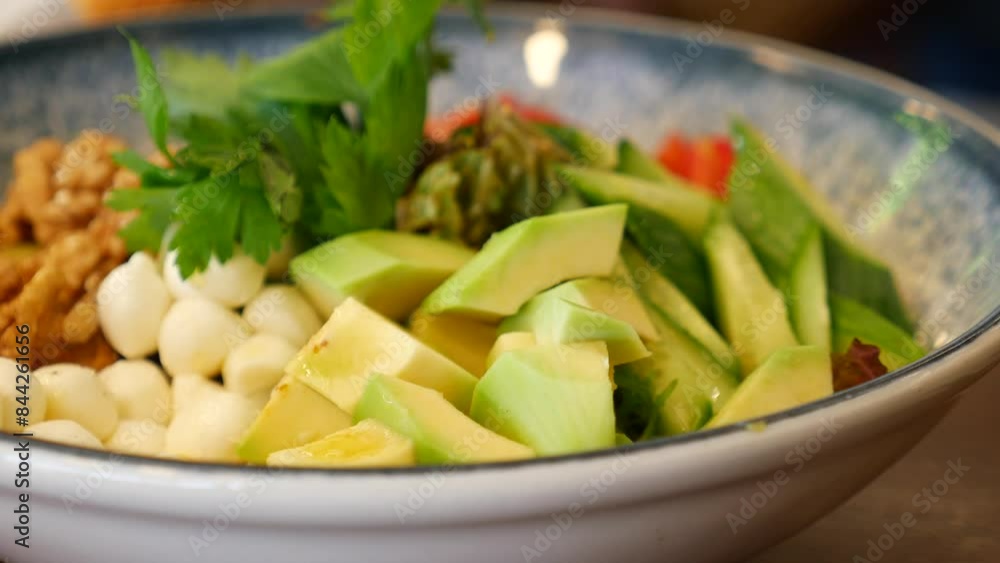 avocado salad with cheese in a bowl on table avocado salad with cheese in a bowl on table