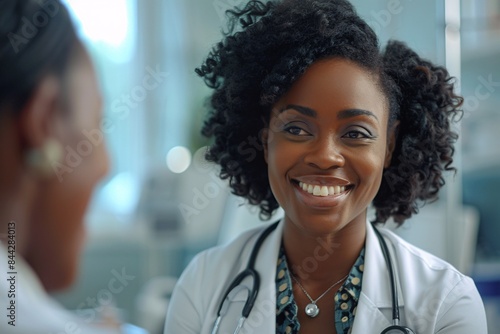 A cheerful female healthcare provider discussing test results or giving advice to an older patient in a hospital meeting.
