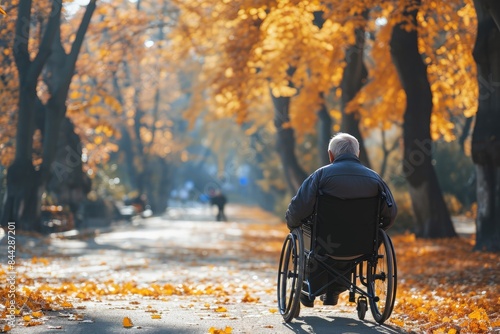 Wallpaper Mural An elderly man rides in a wheelchair in a fall park. A lonely old disabled male on a street strewn with yellow leaves. Torontodigital.ca