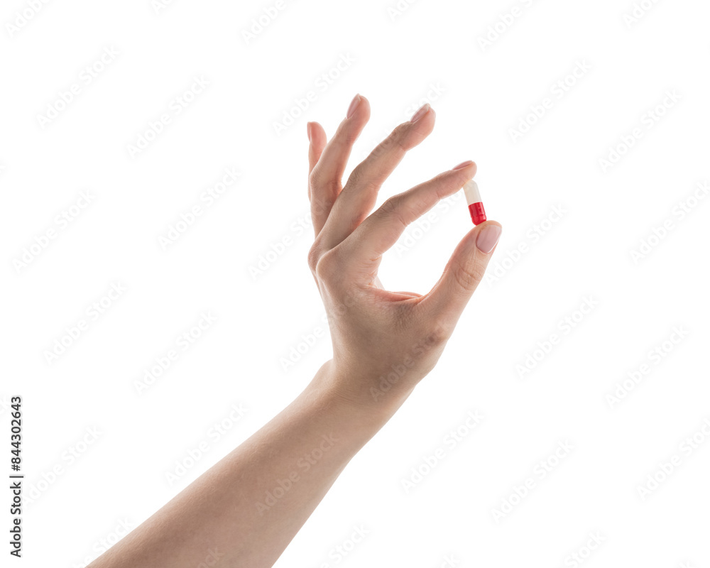 Female hand hold red and white pill isolated on white Female hand hold red and white pill isolated on white