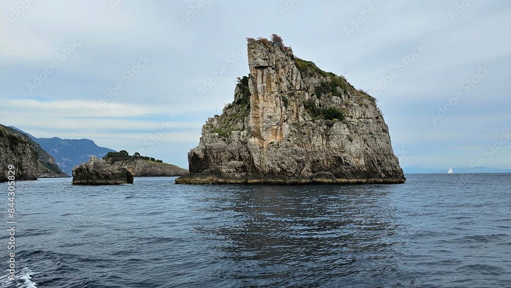 Rocks and mountains on the Amalfi coast in Italy. The island is a rock. View from the yacht. Rocks and mountains on the Amalfi coast in Italy. The island is a rock. View from the yacht.