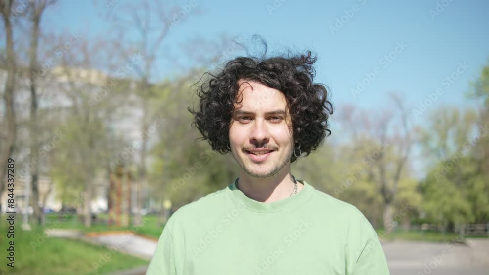 Portrait of man blogger looking at camera on park nature background and smiling Portrait of man blogger looking at camera on park nature background and smiling