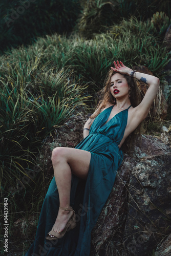 Indigenous woman posing in a garden of cactus and flowers 