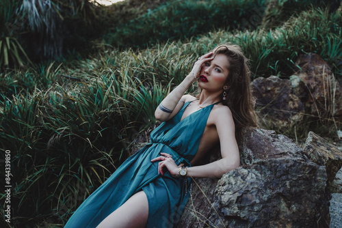 Indigenous woman posing in a garden of cactus and flowers 