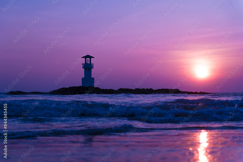 A lighthouse in the ocean during a beautiful sunset A lighthouse in the ocean during a beautiful sunset