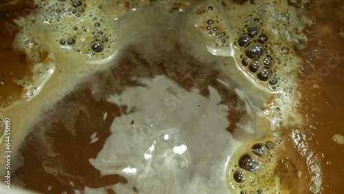 Beer wort boiling while brewing homemade beer close-up