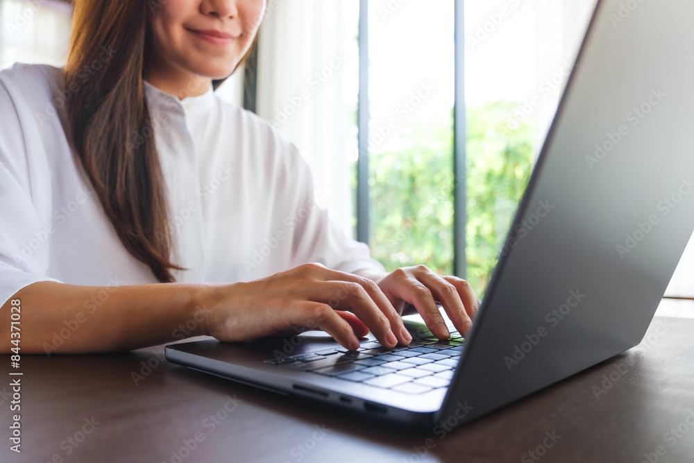 Closeup image of a woman working and typing on laptop computer keyboard Closeup image of a woman working and typing on laptop computer keyboard