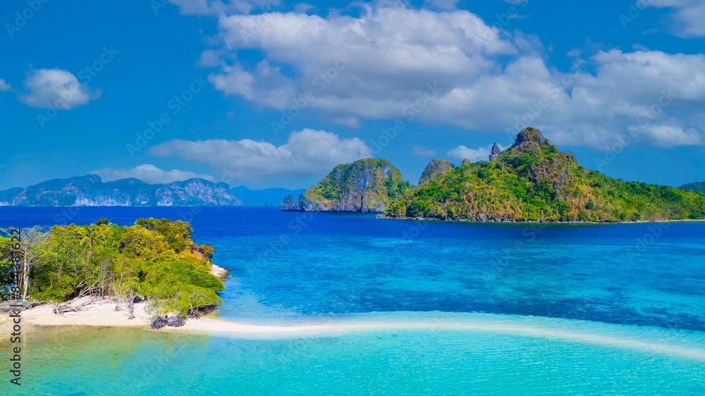 Fototapeta premium Aerail view of tropical exotic island sand bar separating sea in two with turquoise in El Nido, Palawan, Philippines.