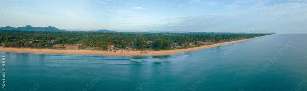 Panoraman aerial drone view of shoreline scenery with blue sea water at Pantai Jambu Bongkok, Marang, Terengganu, Malaysia Panoraman aerial drone view of shoreline scenery with blue sea water at Pantai Jambu Bongkok, Marang, Terengganu, Malaysia