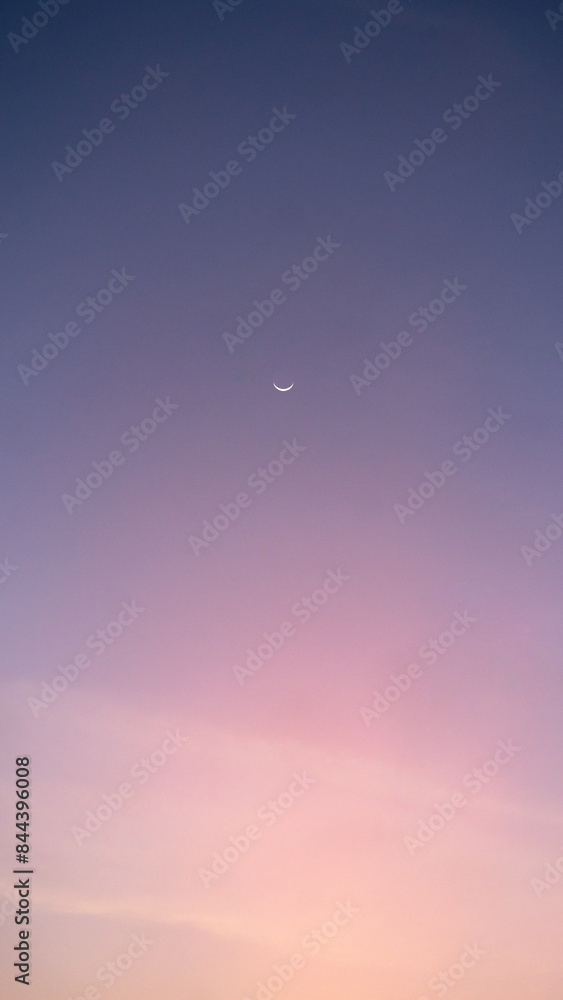 The crescent moon that begins to rise in the afterglow evening sky