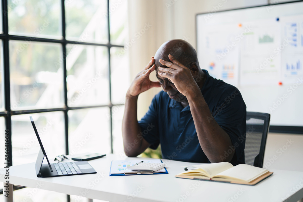 Stressed Businessman at Desk with Laptop and Documents in Modern Office Setting, Analyzing Data and Financial Reports, Experiencing Work Pressure and Fatigue Stressed Businessman at Desk with Laptop and Documents in Modern Office Setting, Analyzing Data and Financial Reports, Experiencing Work Pressure and Fatigue