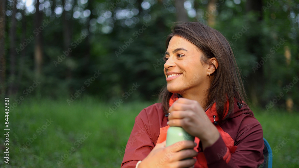 Beautiful, young woman taking a break during hiking and enjoying in the nature Beautiful, young woman taking a break during hiking and enjoying in the nature