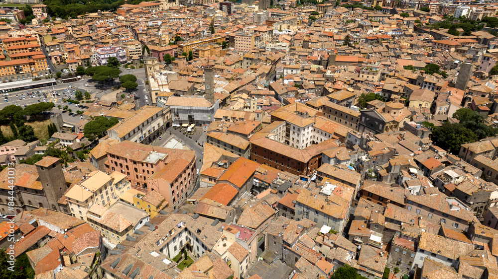 Aerial view of the Civic Tower in Piazza Plebiscito in Viterbo, Lazio, Italy. It is one of the symbols of the historic center of the city. Aerial view of the Civic Tower in Piazza Plebiscito in Viterbo, Lazio, Italy. It is one of the symbols of the historic center of the city.