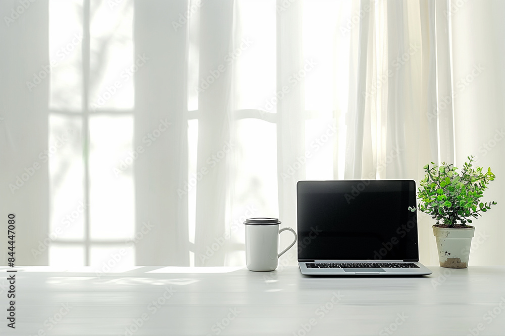 A minimalistic home office setup featuring a laptop, coffee cup, and plant on the table. The scene is set against a clean white background, with natural window light streaming in f A minimalistic home office setup featuring a laptop, coffee cup, and plant on the table. The scene is set against a clean white background, with natural window light streaming in f
