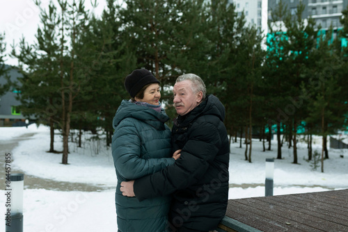 Happy elderly couple walking in the park and confessing their feelings