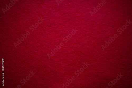 Abstract textured surface red background made of felt fabric with copy space