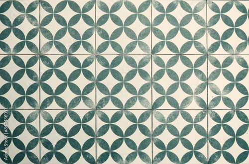 Vintage green and white geometric tiled floor with a worn effect