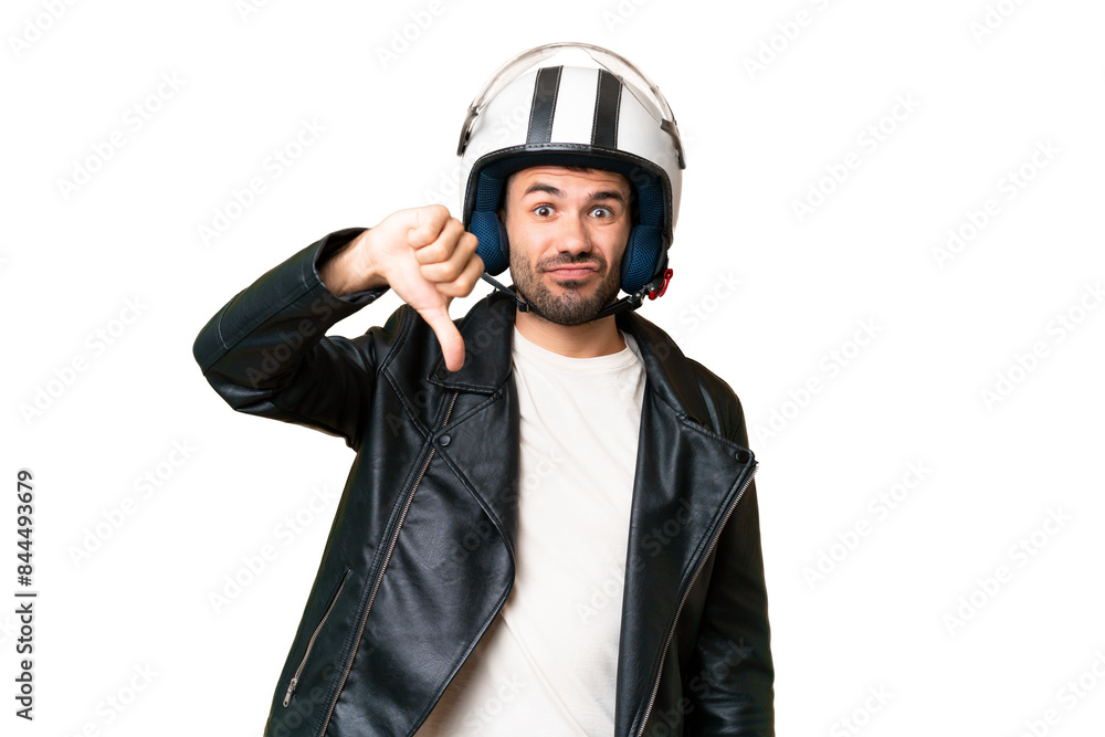 Young caucasian man with a motorcycle helmet over isolated chroma key background showing thumb down with negative expression Young caucasian man with a motorcycle helmet over isolated chroma key background showing thumb down with negative expression