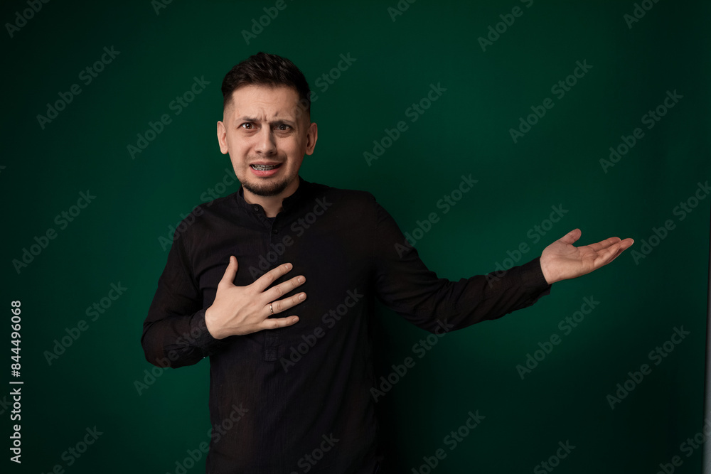 Man Standing in Front of Green Wall Man Standing in Front of Green Wall