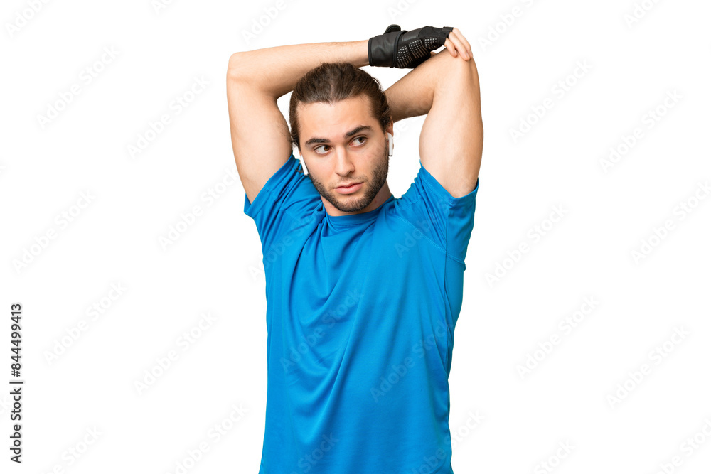 Young handsome man isolated on green chroma background stretching arm Young handsome man isolated on green chroma background stretching arm
