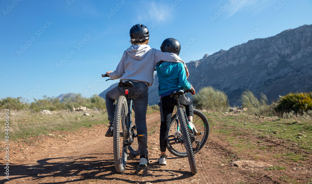 Fototapeta premium children with helmet enjoy having fun riding bike in nature