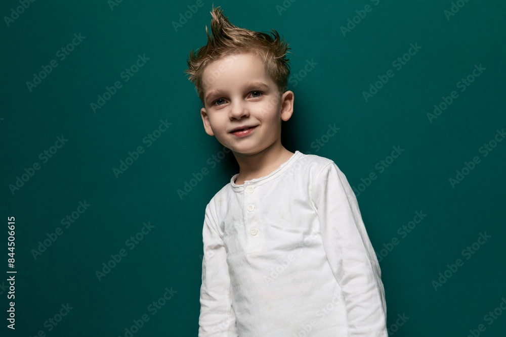 Young Boy Standing in Front of Green Wall Young Boy Standing in Front of Green Wall