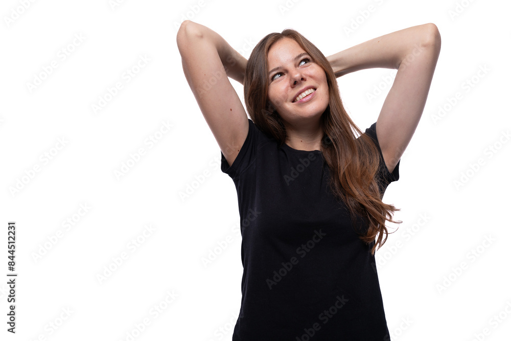 Dreamy young woman with straight hair wearing a black T-shirt on a white background