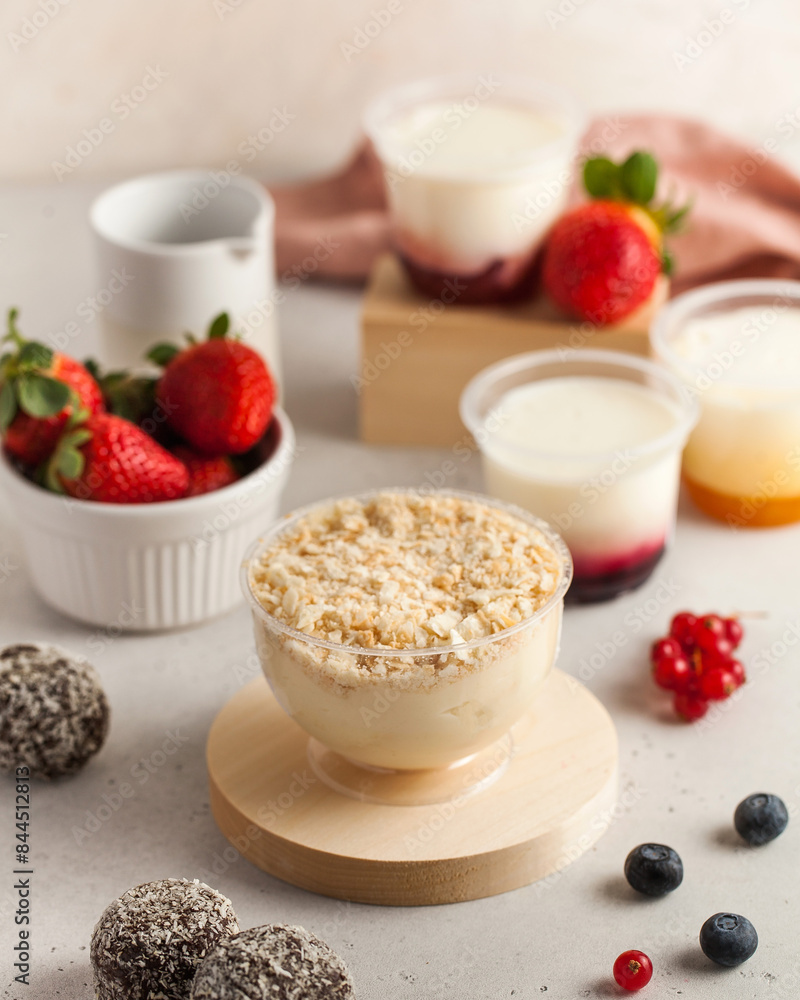 Dairy desserts with berries and candies on kitchen table Dairy desserts with berries and candies on kitchen table