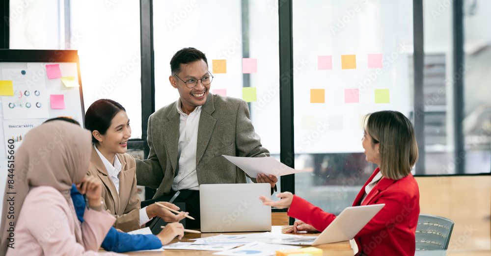 Fototapeta premium Diverse executive business partners group discuss report at boardroom meeting table.
