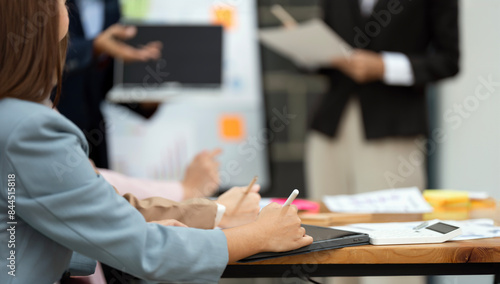 Photos Close-up of business woman writing text on digital tablet during business traini