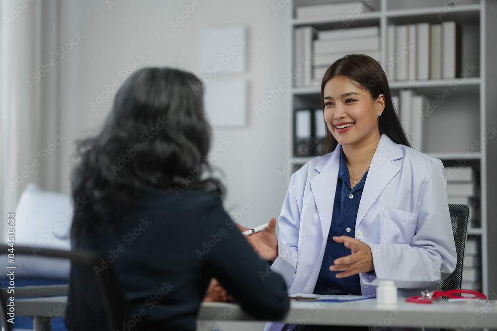 A female doctor in a white coat consulting with a patient in a modern medical office setting. A female doctor in a white coat consulting with a patient in a modern medical office setting.